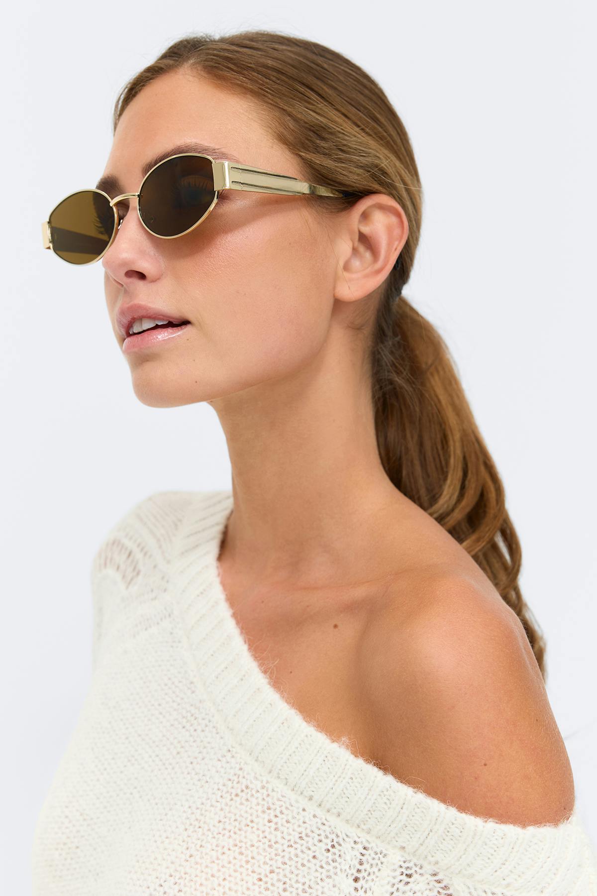 Gold-framed oval sunglasses; chocolate-brown long-sleeve V-neck cropped button-front top with elasticized hem; matching drawstring lounge pants.
