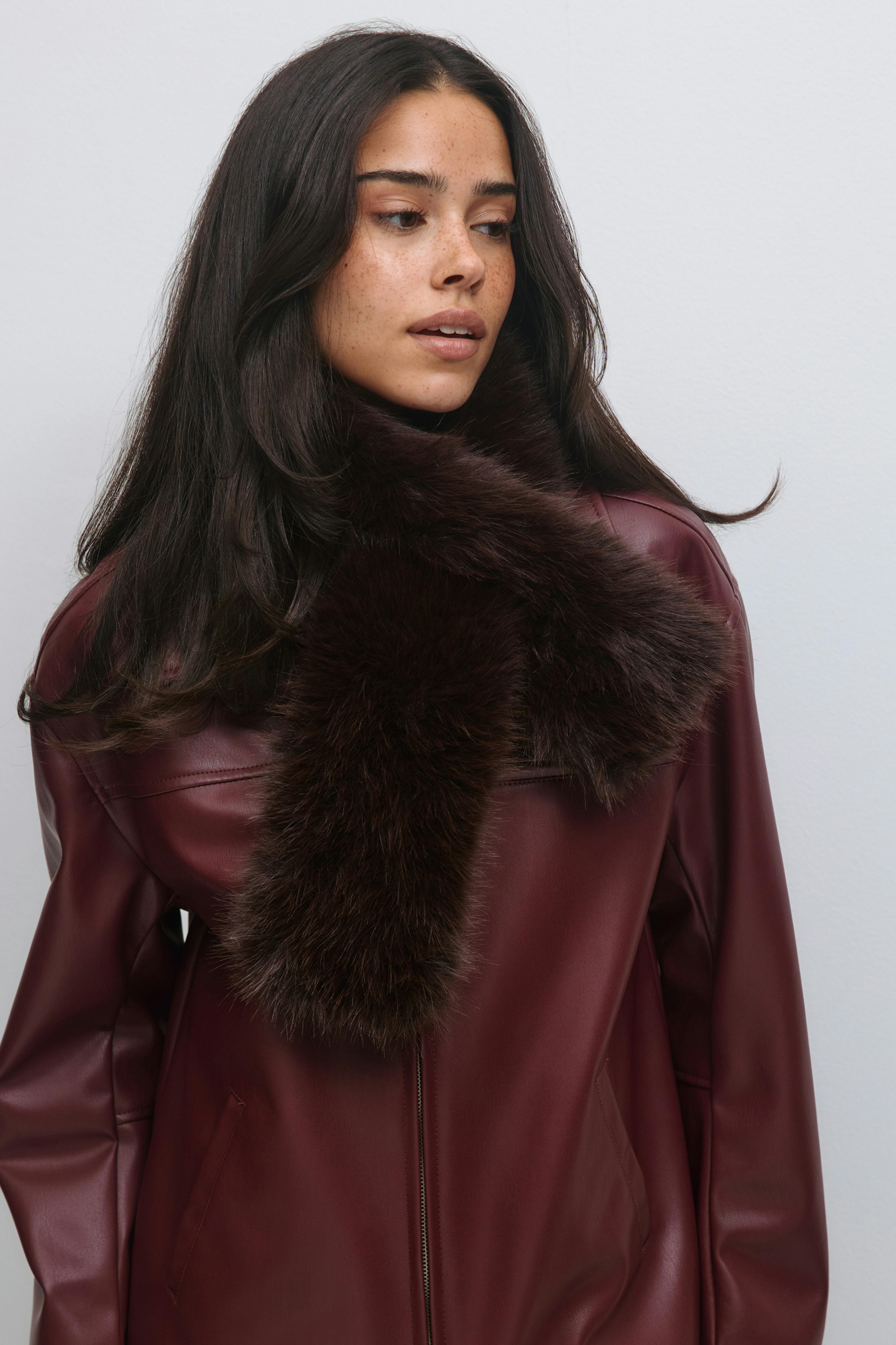 Veste en cuir zippée de couleur bourgogne avec un col en fourrure surdimensionné de couleur marron foncé.
