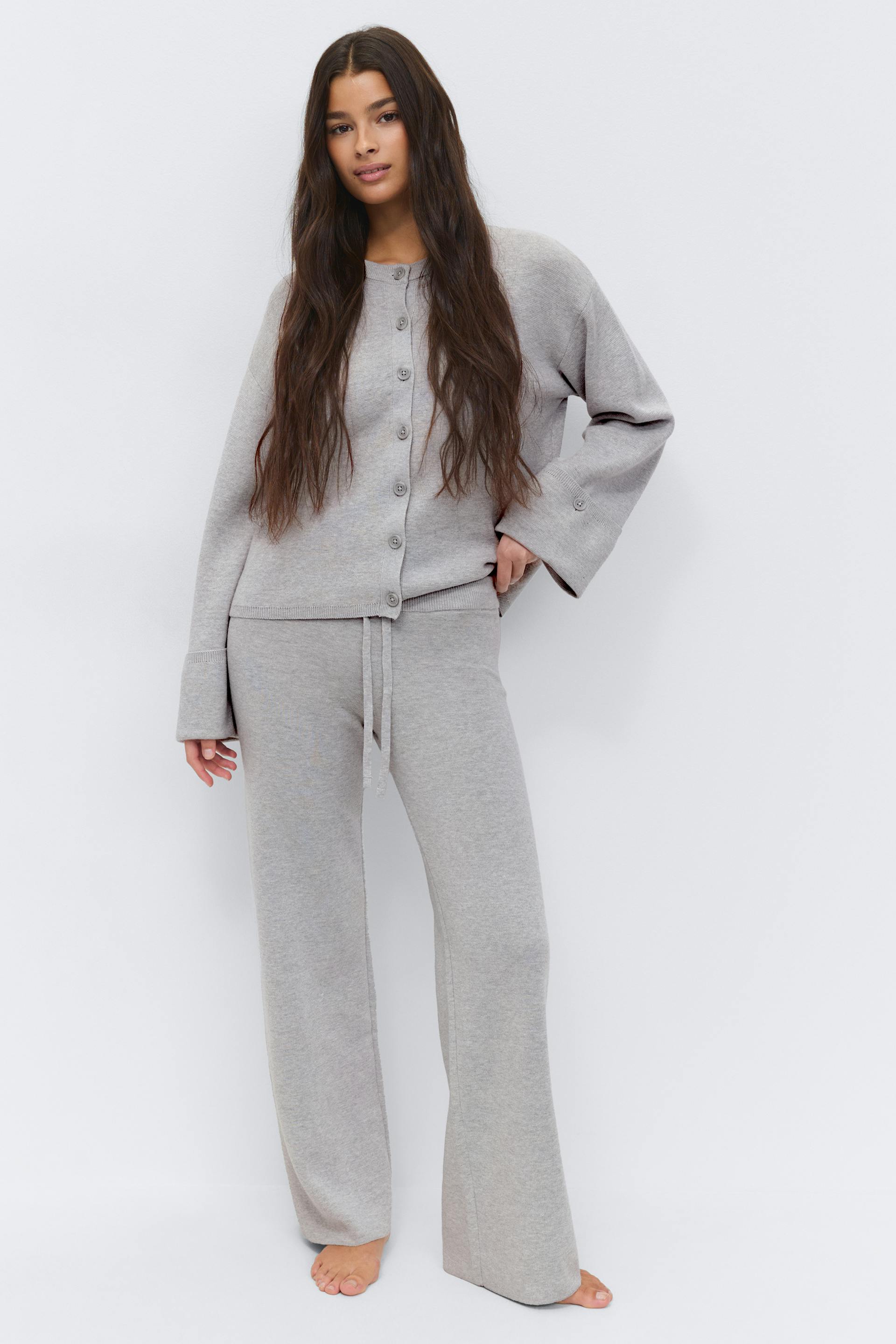 Heather-gray knit button-front cardigan with wide sleeves, paired with matching heather-gray drawstring wide-leg knit trousers.