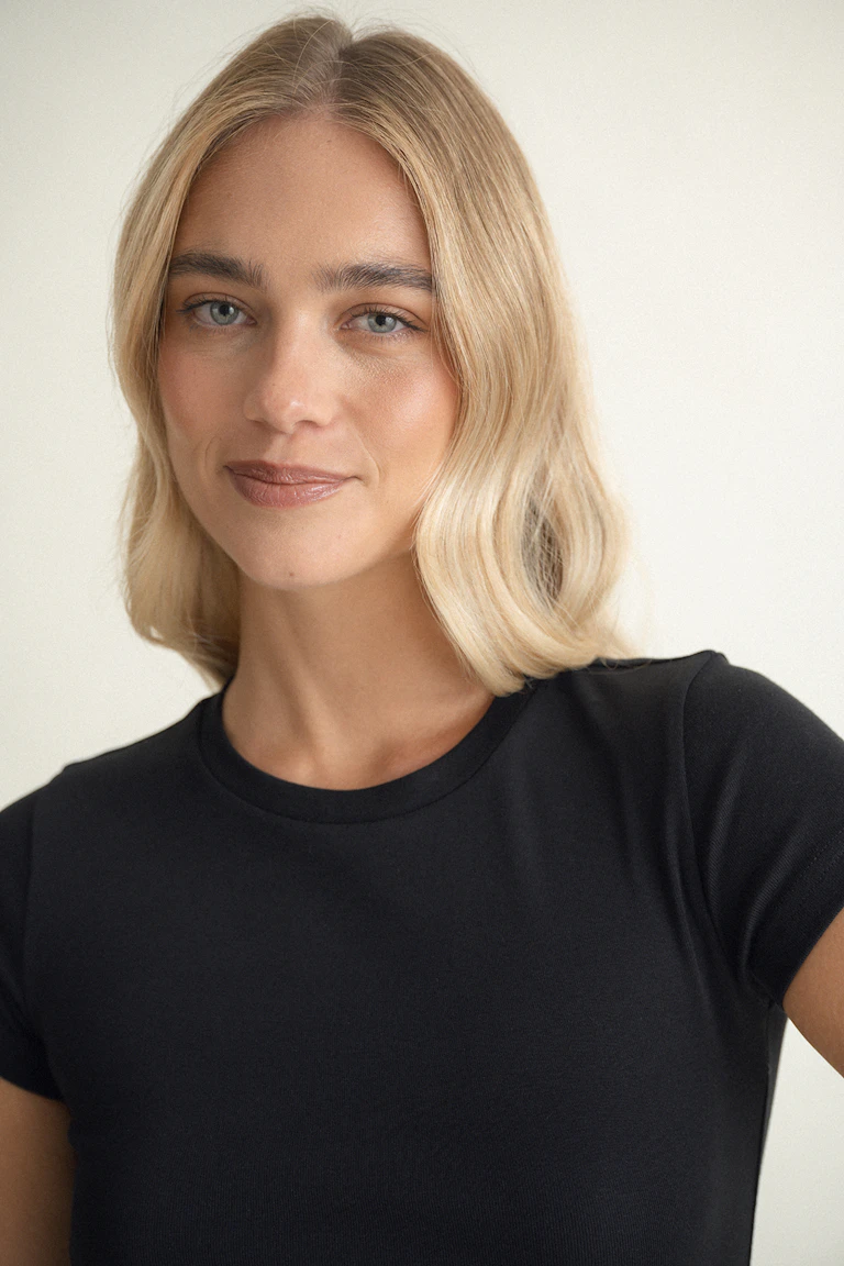 Black fitted short-sleeve crew-neck T-shirt paired with light gray lounge bottoms.