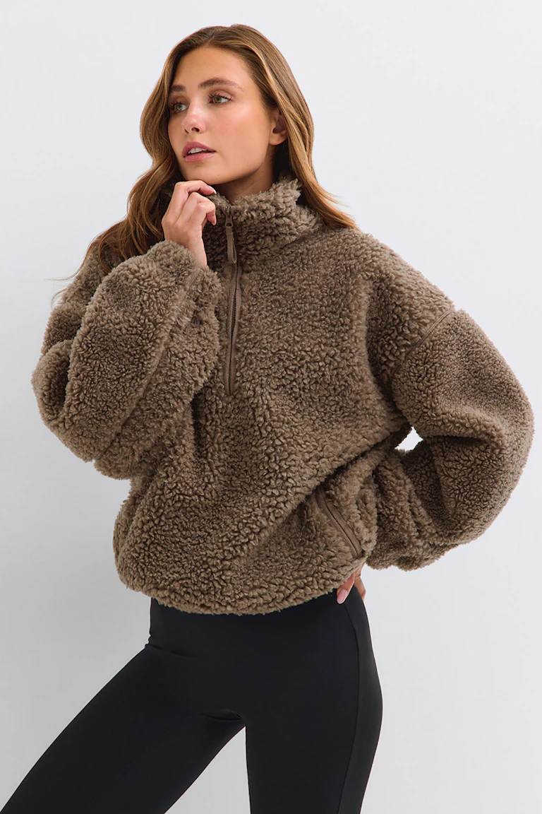 Brown teddy fleece pullover with black leggings.