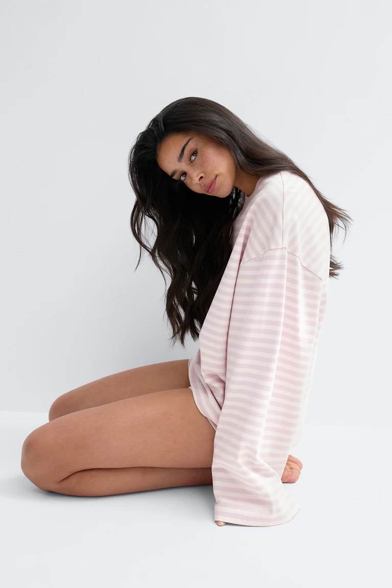 id 310064, StyleColorSupplier 12651: A model wears a pale pink and white striped long-sleeve top.