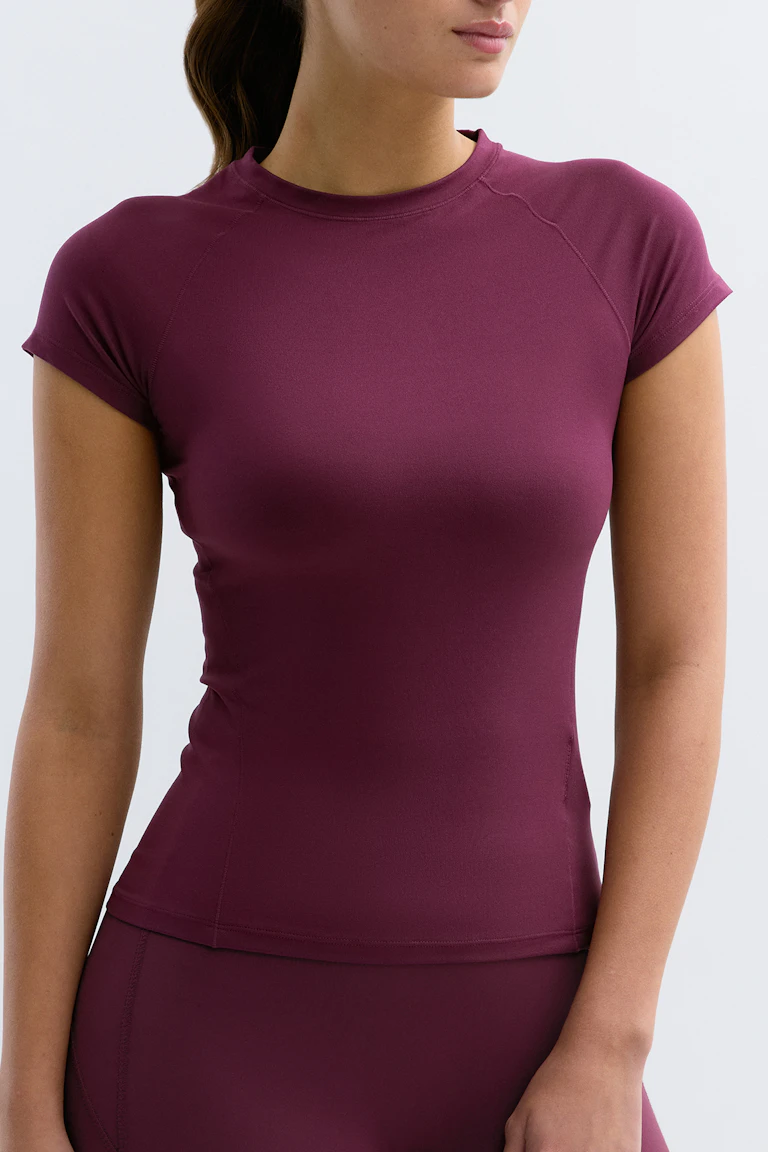 Sportieve top met korte mouwen en bijpassende legging met hoge taille in diep bordeauxrood.