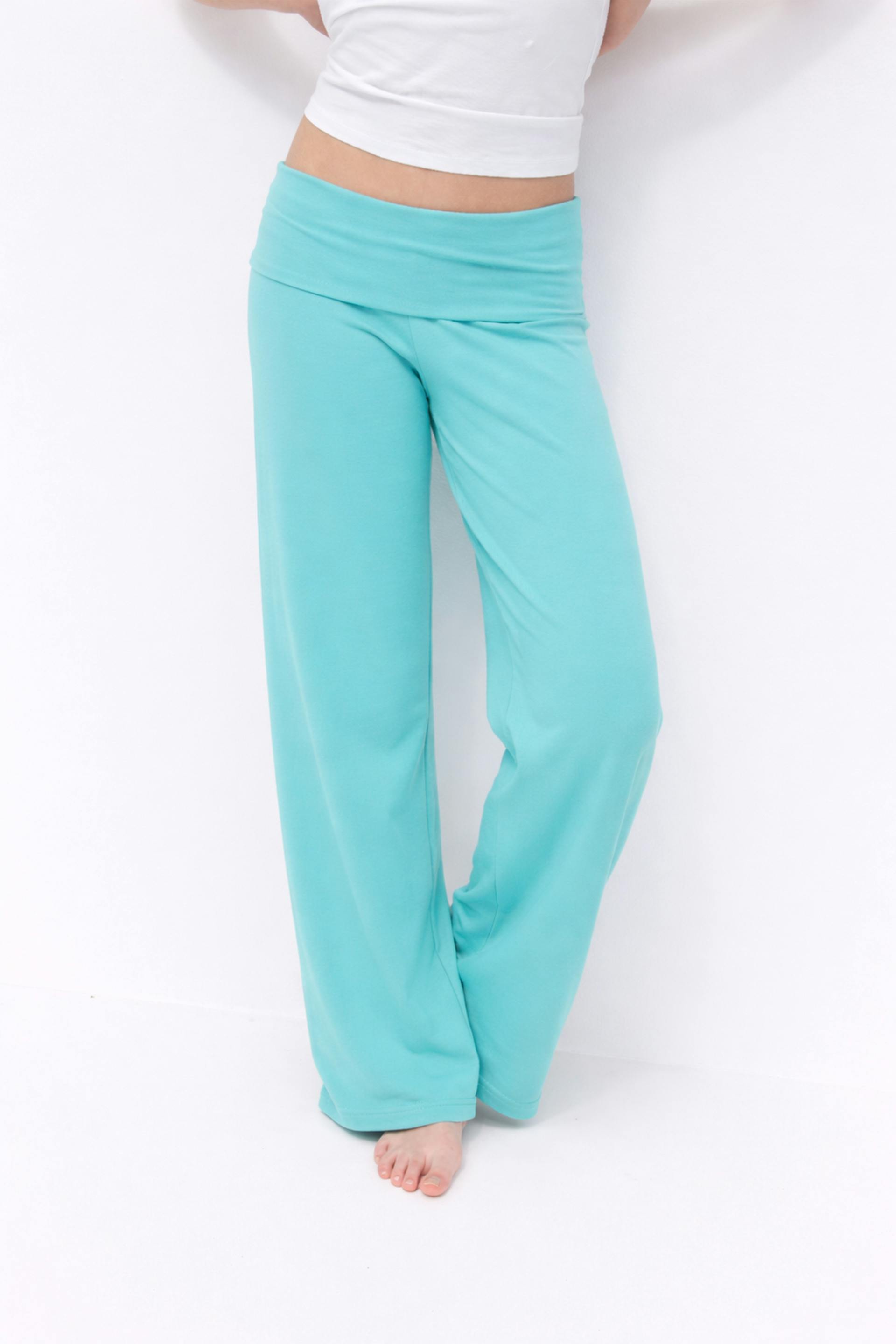 White cropped tank top paired with turquoise fold-over waist, wide-leg lounge pants; barefoot.