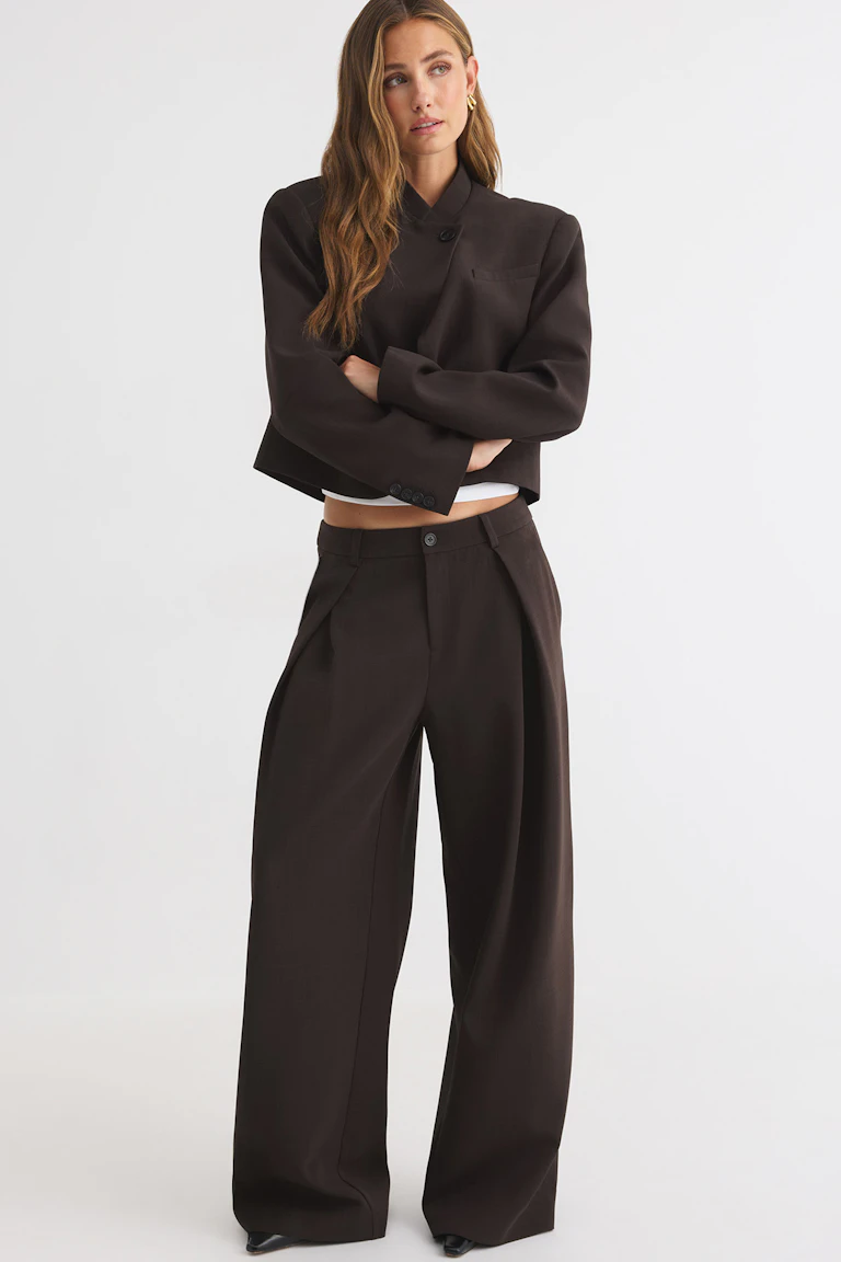 Dark brown cropped tailored jacket with matching wide-leg trousers.