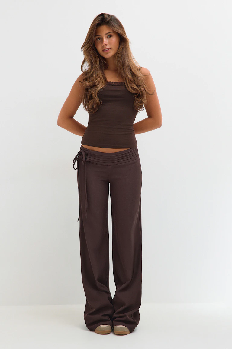 Dark brown lace-trim camisole with matching wide-leg trousers and beige flats.
