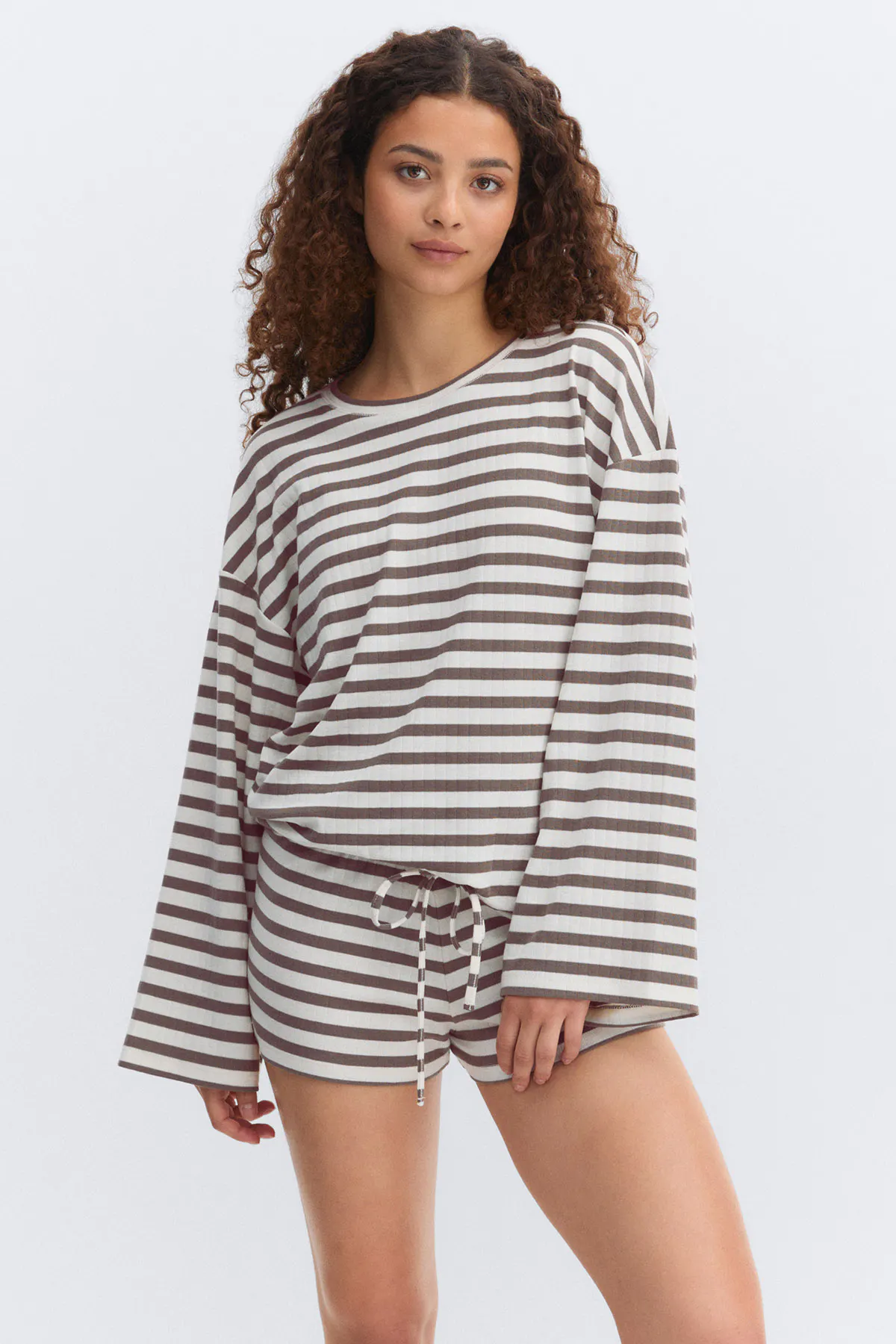 Long-sleeve crewneck top and matching drawstring shorts in white and brown horizontal stripes.