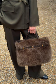 Belted faux fur bag