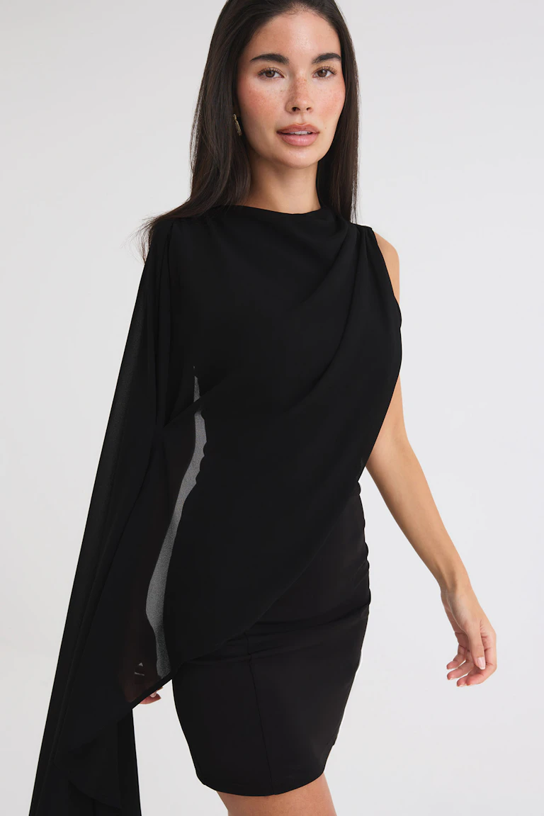 Black one-shoulder mini dress with a sheer draped overlay.