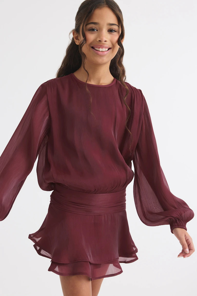 Burgundy long-sleeve chiffon dress with a gathered waist and layered hem.