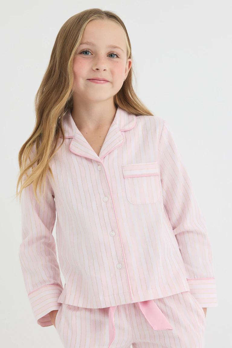 Light pink pinstriped pajama set with a button-up top and matching shorts.